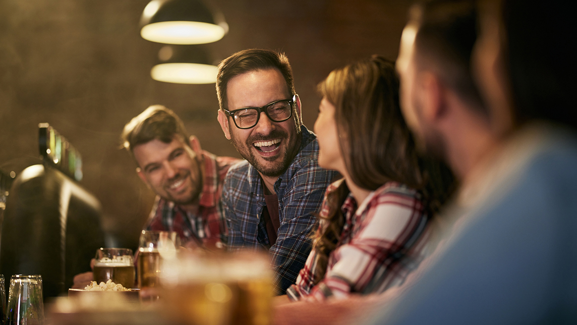 Happy people talk while drinking.