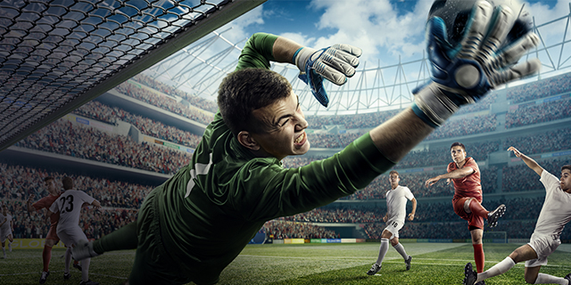 Goal keeper blocking shot at full stretch